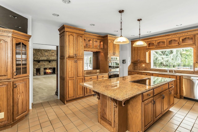 12 Orient Ave, Northport, NY 11768 - kitchen featuring stainless steel appliances, a kitchen island, light tile patterned floors, light stone countertops, and brown cabinetry