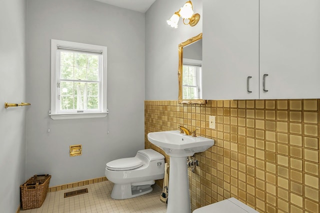 12 Orient Ave, Northport, NY 11768 - half bathroom with tile patterned flooring, tile walls, and a wainscoted wall