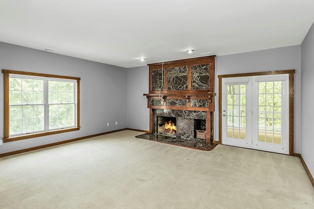 12 Orient Ave, Northport, NY 11768 - unfurnished living room with carpet, a high end fireplace, and plenty of natural light