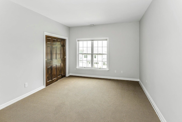12 Orient Ave, Northport, NY 11768 - empty room with dark colored carpet and baseboards