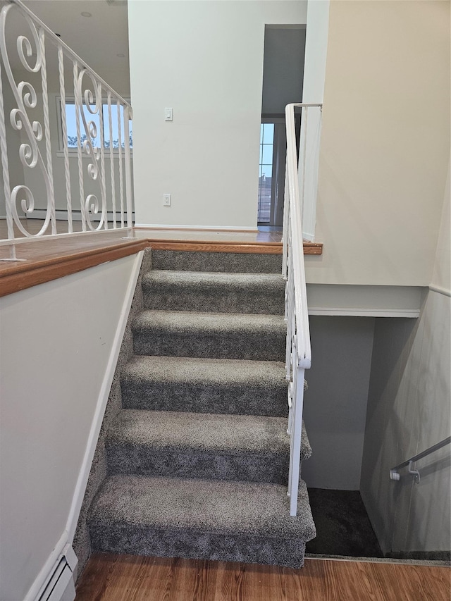 2515 S Seamans Neck Rd, Seaford, NY 11783 - staircase with wood finished floors, a baseboard radiator, and plenty of natural light
