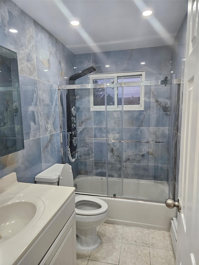 2515 S Seamans Neck Rd, Seaford, NY 11783 - bathroom with vanity, shower / bath combination with glass door, and tile walls