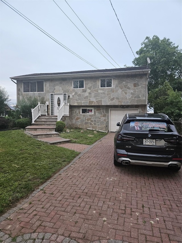 2515 S Seamans Neck Rd, Seaford, NY 11783 - view of front of home featuring stone siding, decorative driveway, a front yard, and a garage
