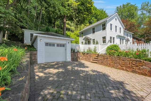 115 River Rd, Nyack, NY 10960 - view of front of house featuring an outdoor structure, a detached garage, and decorative driveway