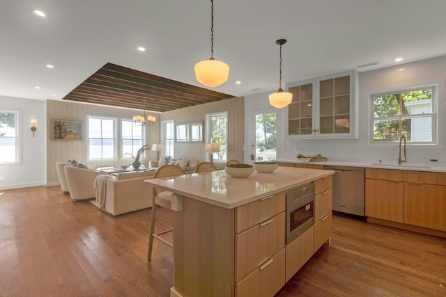 115 River Rd, Nyack, NY 10960 - kitchen with dishwasher, wood finished floors, a breakfast bar, light countertops, and recessed lighting