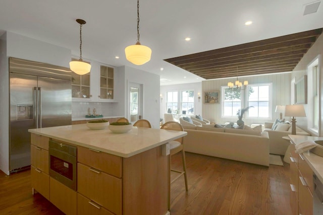 115 River Rd, Nyack, NY 10960 - kitchen featuring built in fridge, a kitchen breakfast bar, dark wood-type flooring, open floor plan, and light countertops