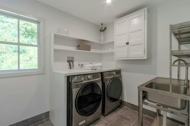 115 River Rd, Nyack, NY 10960 - washroom with washing machine and dryer, plenty of natural light, and dark tile patterned flooring