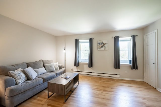 1000 Ninth St Unit H63, Greenport, NY 11944 - living area featuring baseboard heating, plenty of natural light, and light wood-style flooring