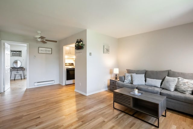 1000 Ninth St Unit H63, Greenport, NY 11944 - living area featuring a baseboard heating unit, a wall unit AC, light wood-style floors, and ceiling fan