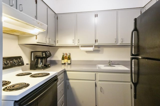 1000 Ninth St Unit H63, Greenport, NY 11944 - kitchen featuring freestanding refrigerator, range with electric stovetop, extractor fan, and light countertops