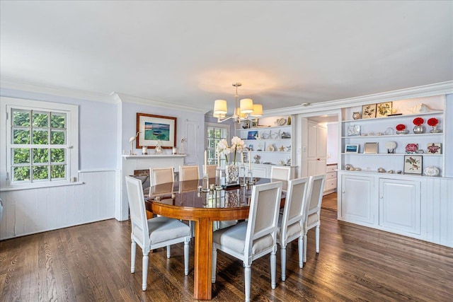 50 Shore Rd, Cold Spring Harbor, NY 11724 - dining area with a chandelier, ornamental molding, wainscoting, wood finished floors, and built in shelves