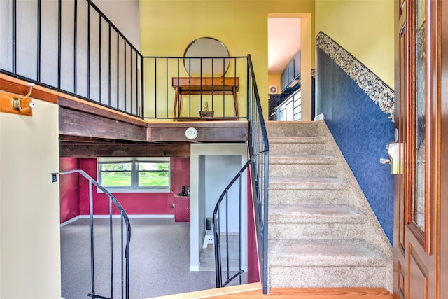 3 Twig Ct, East Setauket, NY 11733 - stairway featuring a high ceiling and baseboards
