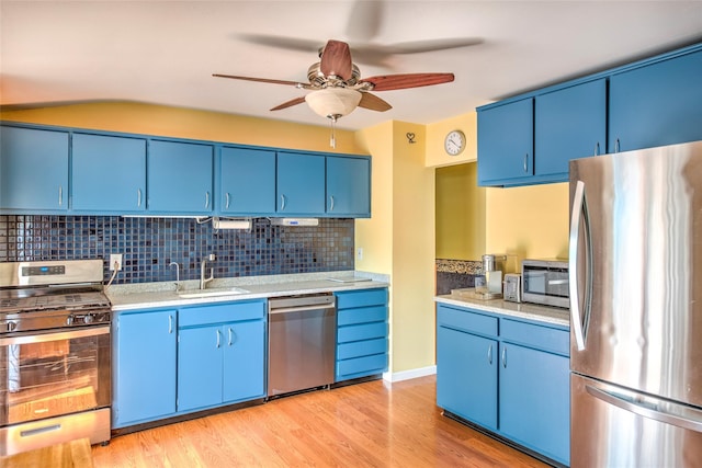3 Twig Ct, East Setauket, NY 11733 - kitchen featuring stainless steel appliances, blue cabinets, a ceiling fan, and light countertops