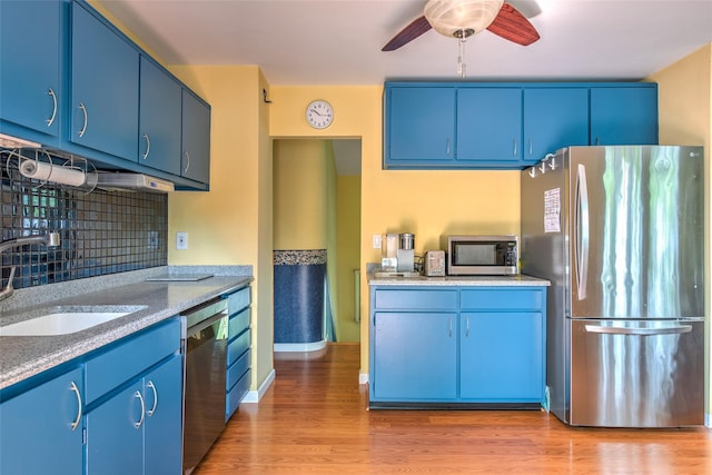 3 Twig Ct, East Setauket, NY 11733 - kitchen featuring appliances with stainless steel finishes, blue cabinetry, and backsplash
