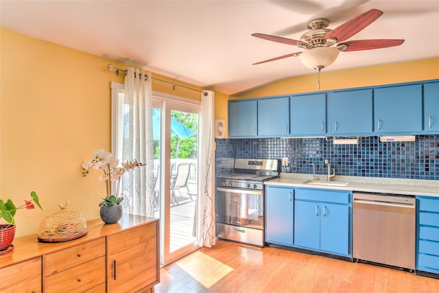 3 Twig Ct, East Setauket, NY 11733 - kitchen featuring appliances with stainless steel finishes, blue cabinets, backsplash, and lofted ceiling