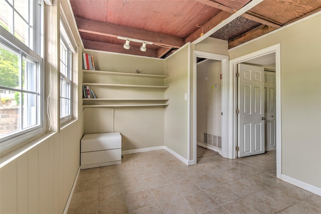 3 Twig Ct, East Setauket, NY 11733 - empty room featuring wooden ceiling, light tile patterned flooring, and rail lighting