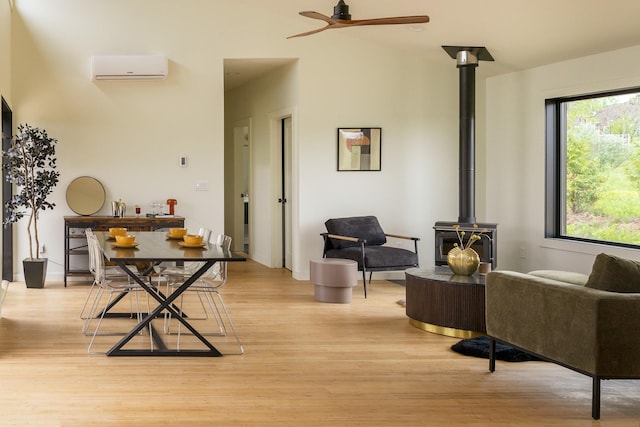 612 Beechwoods Rd, Callicoon, NY 12723 - living area featuring light wood finished floors, a wood stove, and an AC wall unit