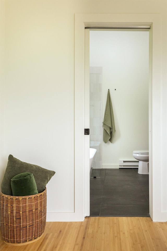 612 Beechwoods Rd, Callicoon, NY 12723 - full bathroom with a baseboard heating unit, a tub, and wood finished floors