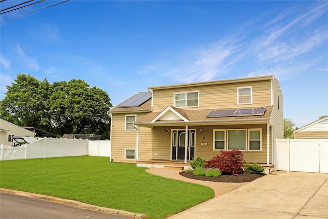 6 Robinhood Dr, East Islip, NY 11730 - traditional-style home featuring roof mounted solar panels, a porch, a fenced backyard, and a shingled roof