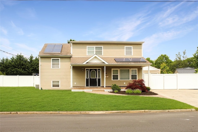 6 Robinhood Dr, East Islip, NY 11730 - view of front of home featuring roof mounted solar panels, a porch, driveway, a shingled roof, and a gate
