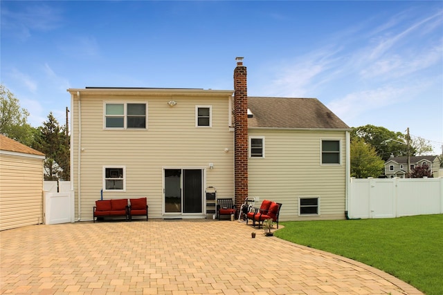 6 Robinhood Dr, East Islip, NY 11730 - rear view of house featuring a patio, a chimney, and a gate