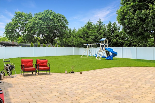6 Robinhood Dr, East Islip, NY 11730 - fenced backyard featuring a playground and a patio area