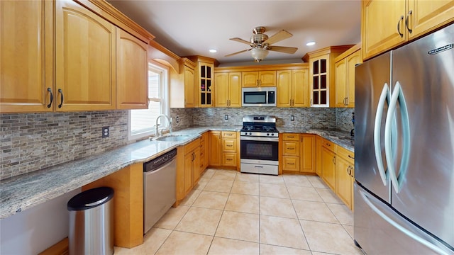 6 Robinhood Dr, East Islip, NY 11730 - kitchen with stainless steel appliances, stone countertops, light tile patterned floors, ceiling fan, and glass insert cabinets
