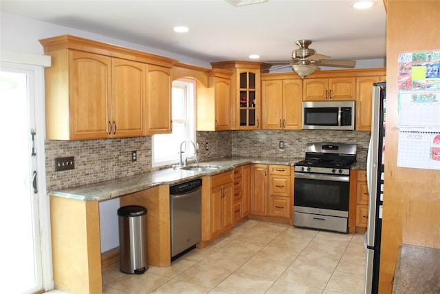 6 Robinhood Dr, East Islip, NY 11730 - kitchen featuring appliances with stainless steel finishes, healthy amount of natural light, decorative backsplash, light stone countertops, and recessed lighting