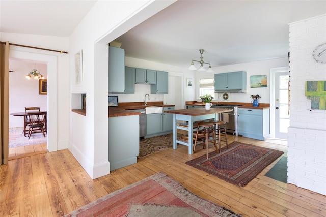 132 Decker, Ancram, NY 12502 - kitchen with wooden counters, stove, light wood-type flooring, and blue cabinets