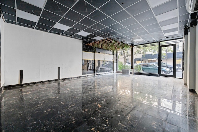 6050 71st Ave, Ridgewood, NY 11385 - unfurnished room with expansive windows, a drop ceiling, and marble tiled flooring
