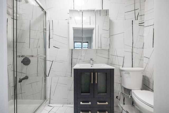 6050 71st Ave, Ridgewood, NY 11385 - bathroom with tile walls, a stall shower, vanity, and marble finish floors