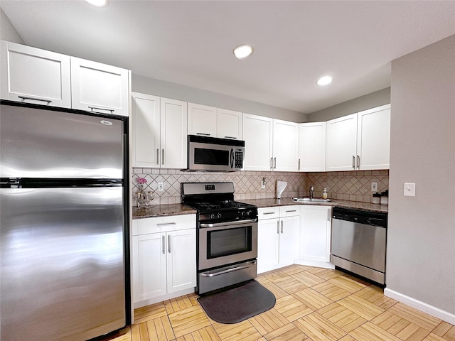1600 Parkview Ave Unit 6A, Bronx, NY 10461 - kitchen featuring appliances with stainless steel finishes, white cabinets, tasteful backsplash, recessed lighting, and dark stone countertops