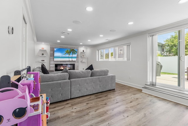 270 Farmers Ave, Lindenhurst, NY 11757 - living room with crown molding, wood finished floors, recessed lighting, a large fireplace, and healthy amount of natural light