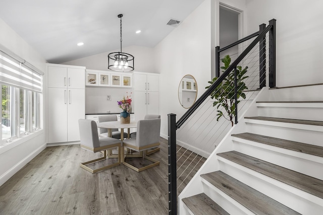 270 Farmers Ave, Lindenhurst, NY 11757 - dining room with stairway, a chandelier, vaulted ceiling, light wood-style flooring, and recessed lighting