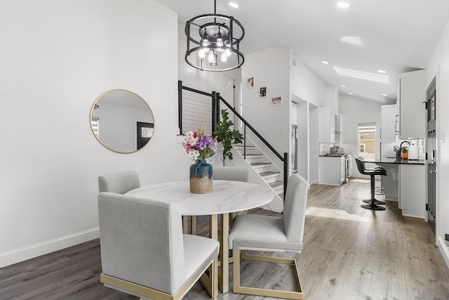 270 Farmers Ave, Lindenhurst, NY 11757 - dining space featuring stairs, light wood finished floors, a chandelier, recessed lighting, and lofted ceiling