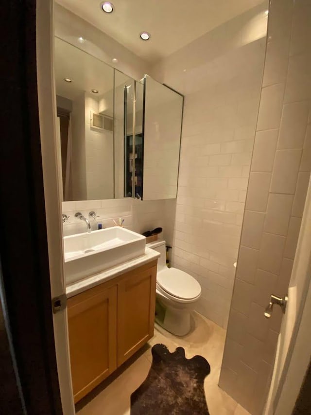 33-47 91st St Unit 5A, Jackson Heights, NY 11372 - bathroom featuring vanity, tile walls, recessed lighting, and tile patterned floors