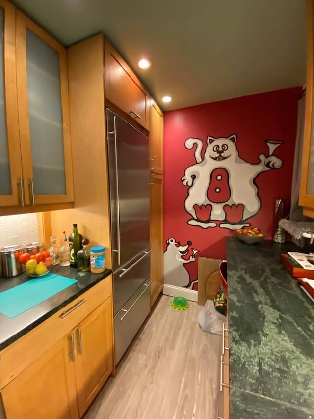 33-47 91st St Unit 5A, Jackson Heights, NY 11372 - kitchen with built in fridge, light wood-style floors, glass insert cabinets, dark countertops, and recessed lighting