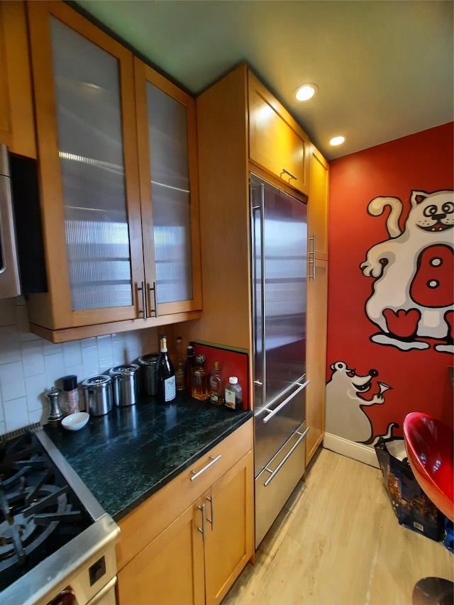 33-47 91st St Unit 5A, Jackson Heights, NY 11372 - kitchen with stainless steel built in fridge, light wood-style floors, stove, glass insert cabinets, and backsplash