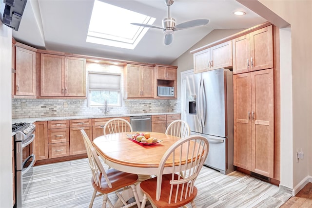 24 Oxford Ct, Spring Valley, NY 10977 - kitchen featuring appliances with stainless steel finishes, ceiling fan, tasteful backsplash, a skylight, and lofted ceiling