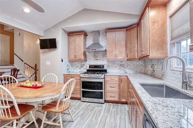 24 Oxford Ct, Spring Valley, NY 10977 - kitchen featuring double oven range, wall chimney exhaust hood, vaulted ceiling, backsplash, and light stone countertops