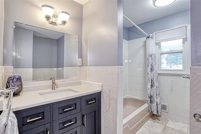 24 Oxford Ct, Spring Valley, NY 10977 - full bathroom with tile walls, vanity, shower / bath combo, and a wainscoted wall