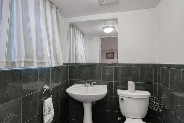 24 Oxford Ct, Spring Valley, NY 10977 - bathroom featuring toilet and tile walls