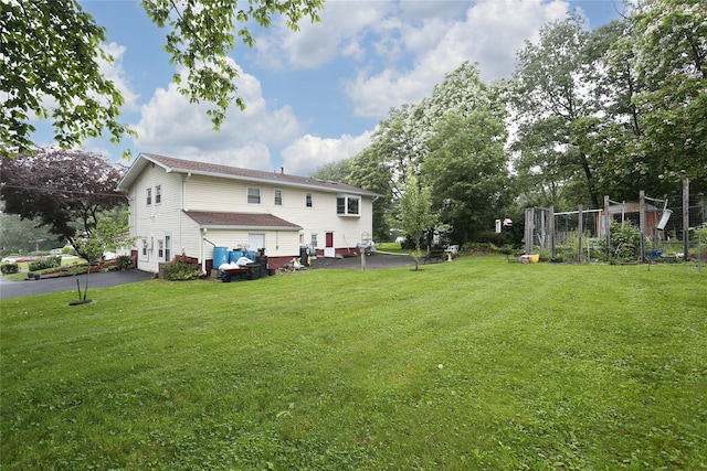 24 Oxford Ct, Spring Valley, NY 10977 - back of property with a yard and driveway