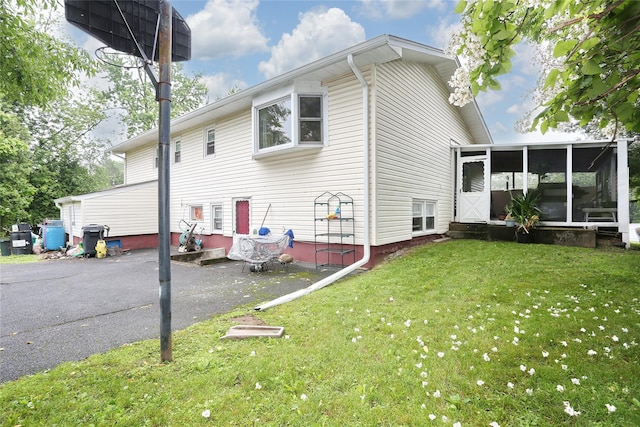 24 Oxford Ct, Spring Valley, NY 10977 - view of property exterior with a sunroom and a yard