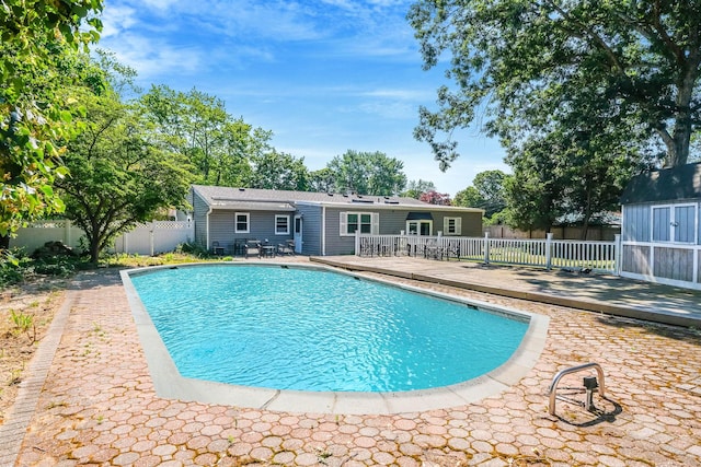 16 Marlin Rd, Centereach, NY 11720 - view of swimming pool with a wooden deck, a fenced backyard, and a storage unit