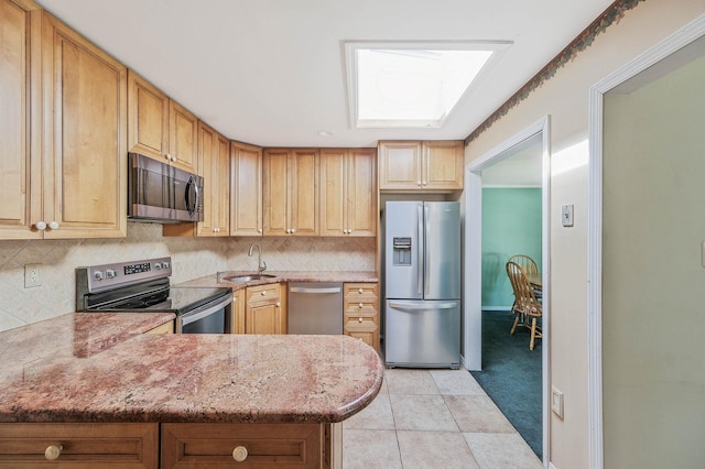 16 Marlin Rd, Centereach, NY 11720 - kitchen with appliances with stainless steel finishes, decorative backsplash, light stone countertops, and a peninsula