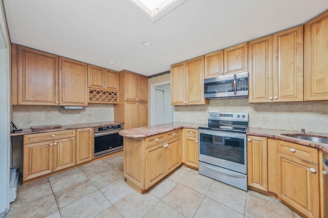 16 Marlin Rd, Centereach, NY 11720 - kitchen with stainless steel appliances, tasteful backsplash, a peninsula, light stone counters, and light tile patterned floors