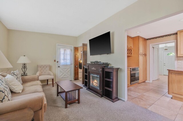 16 Marlin Rd, Centereach, NY 11720 - living area with a glass covered fireplace, light tile patterned floors, and light colored carpet