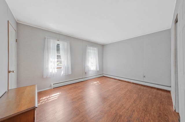 16 Marlin Rd, Centereach, NY 11720 - empty room featuring wood finished floors, a baseboard heating unit, and crown molding