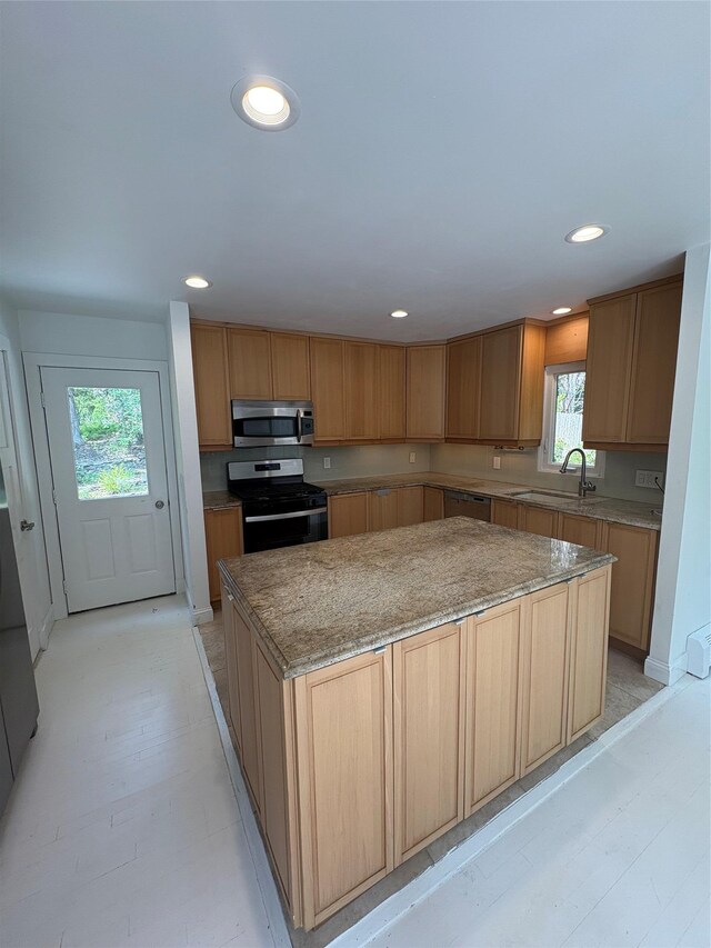 165 Roses Grove Rd, Water Mill, NY 11976 - kitchen featuring appliances with stainless steel finishes, a kitchen island, recessed lighting, and light stone counters